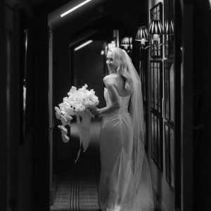 Brides looking behind shoulder in hallway